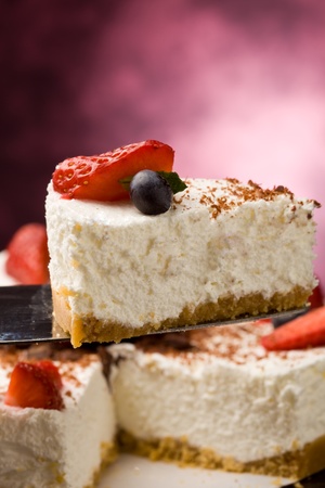 photo of delicious cake with strawberries on wooden tableの写真素材