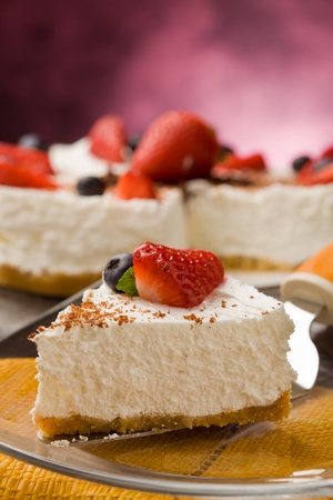 photo of delicious cake with strawberries on wooden tableの写真素材