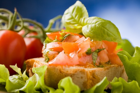 photo of delicious bruschetta appetizer with tomatoes and basilの写真素材