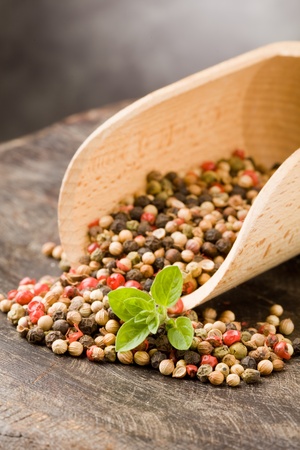 photo of shovel with mixed pepper beans inside on wooden tableの写真素材