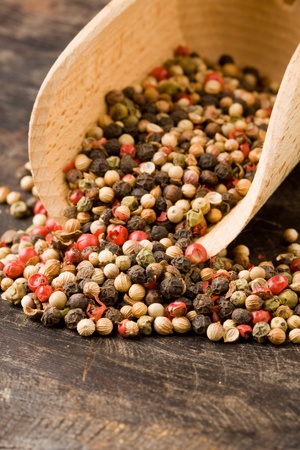 photo of shovel with mixed pepper beans inside on wooden tableの写真素材
