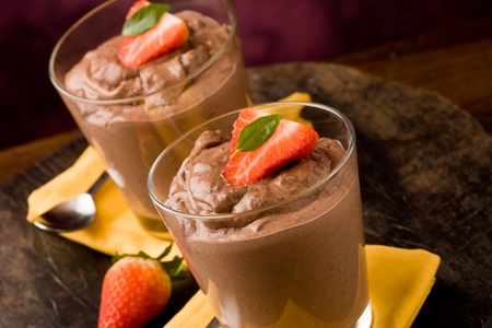phot of delicious chocolate mousse with strawberries and yellow napkinsの写真素材