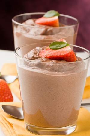 phot of delicious chocolate mousse with strawberries and yellow napkinsの写真素材
