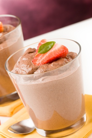 phot of delicious chocolate mousse with strawberries and yellow napkinsの写真素材