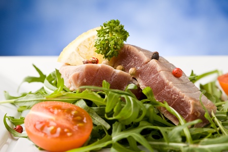 photo of sliced Tuna Steak with arugula salad and ingredients arroundの写真素材