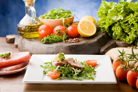 photo of sliced Tuna Steak with arugula salad and ingredients arroundの写真素材