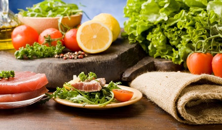 photo of sliced Tuna Steak with arugula salad and ingredients arroundの写真素材