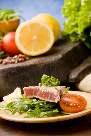 photo of sliced Tuna Steak with arugula salad and ingredients arroundの写真素材