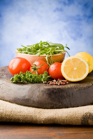 photo of different vegetables on wooden chopping board ready for cookingの写真素材