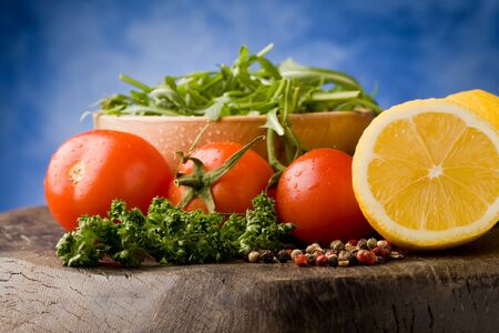 photo of different vegetables on wooden chopping board ready for cookingの写真素材