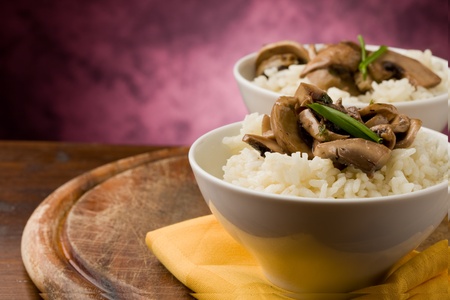 photo of delicious risotto with mushrooms on wooden tableの写真素材
