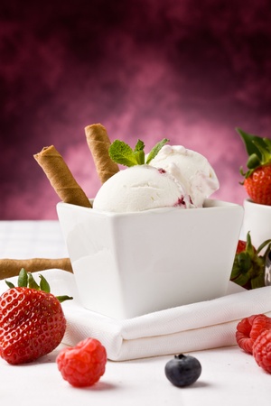 photo of delicious ice cream with berries on the table の写真素材
