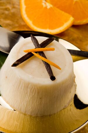 photo of delicious vanilla orange pudding on golden plate の写真素材