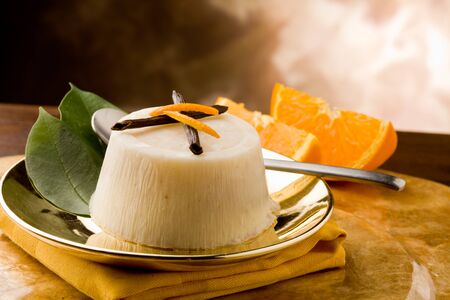 photo of delicious vanilla orange pudding on golden plate の写真素材