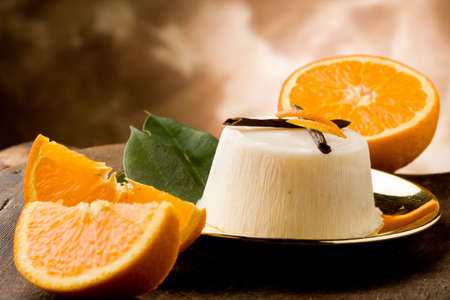 photo of delicious vanilla orange pudding on golden plate の写真素材