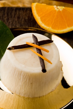 photo of delicious vanilla orange pudding on golden plate の写真素材