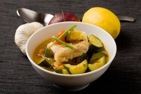 photo of delicious fish soup with cod and zucchiniの写真素材