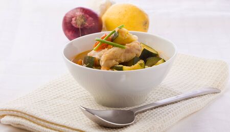 photo of delicious fish soup with cod and zucchiniの写真素材