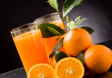 photo of fresh orange juice with water drops and green leavesの写真素材
