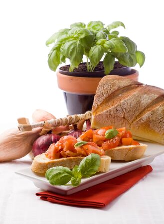 photo of delicious italian bruschetta with basil and ingredientsの写真素材