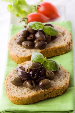photo of delicious sliced bread with olives and basilの写真素材