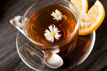 photo of delicious lemon tea with lemon slices and marguerite insideの写真素材