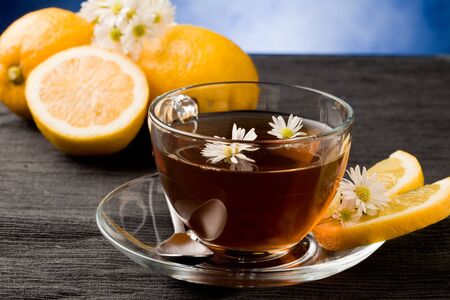 photo of delicious lemon tea with lemon slices and marguerite insideの写真素材