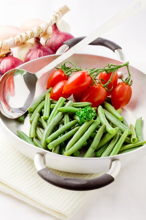 photo of french beans inside a pan with cherry tomatoesの写真素材