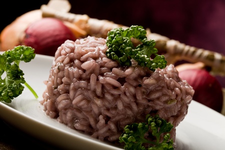 photo of delicious risotto with red wine on wooden table の写真素材