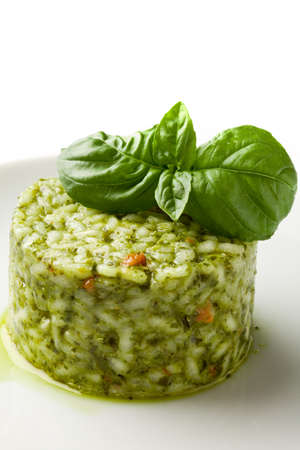 photo of delicious risotto with basil on white isolated backgroundの写真素材