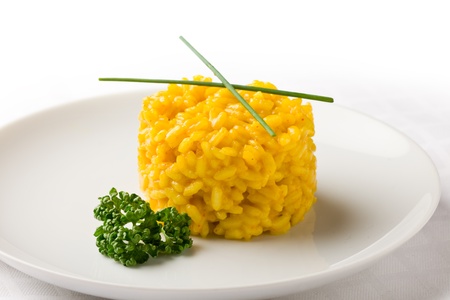 photo of delicious yellow risotto with saffron on white isolated backgroundの写真素材