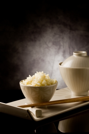delicious asian rice plate with chopsticks on glass tableの写真素材