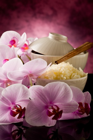 delicious asian rice dish with orchid flowers aroundの写真素材