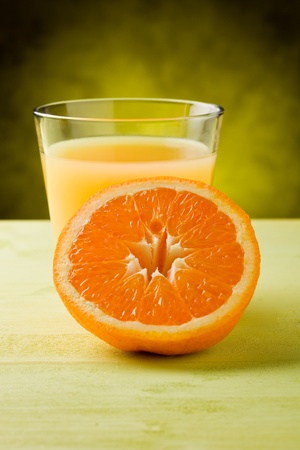 fresh orange juice inside a glass on wooden table の写真素材