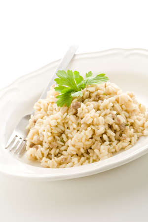  delicious italian risotto dish with meat and parsley on white isolated backgroundの写真素材