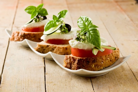 delicious sliced cereal bread with tomato mozzarella の写真素材