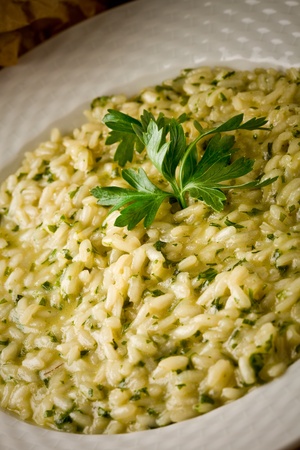 photo of delicious risotto dish with herbs on wooden tableの写真素材