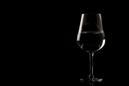 photo of highlighted wine glass edges on black backgroundの写真素材