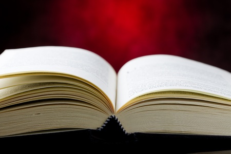 photo of a book which is open in front of a red rural backgroundの写真素材