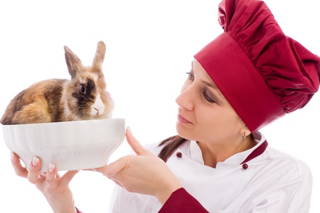 photo of succesfull female restaurant chef with rabbit inside a bowlの写真素材