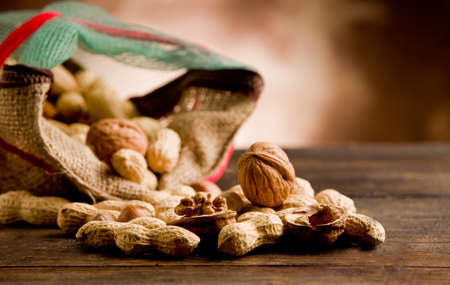 photo of differents nuts inside a cloth on wooden table 