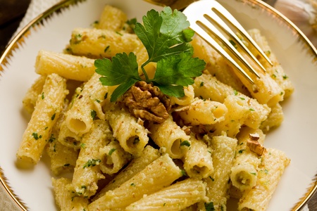 Italian regional dish made of pasta with walnut pesto on wooden table の写真素材