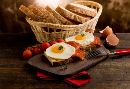conceptual photo of english breakfast with fried eggs and bacon on wooden table