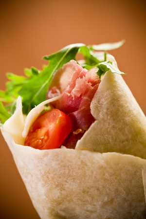 Delicious tortillas stuffed with bacon and colorful arugula saladの写真素材