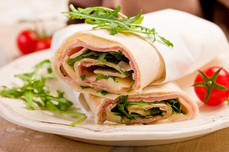 Delicious tortillas stuffed with bacon and colorful arugula saladの写真素材