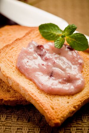 fresh rusks for breakfast with butter and honey on brown towel の写真素材