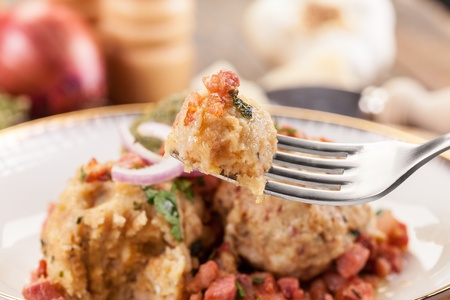 North Italian Traditional plate of canederli pasta with diced baconの写真素材