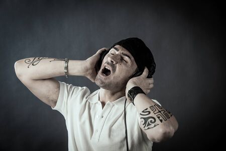 photo of young dj with headphones singing his song の写真素材