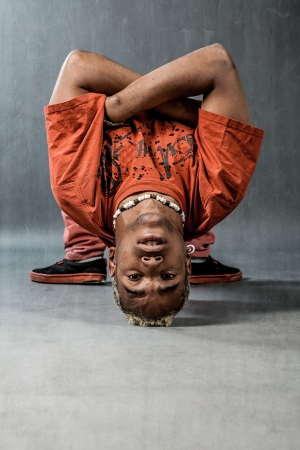 image of a  break dancer who is performing his move 
