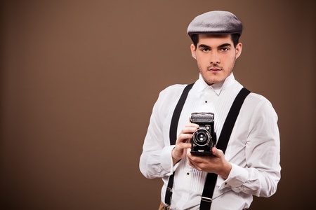 Photo of cute guy with old dslr camera and old outfit from the 30sの写真素材